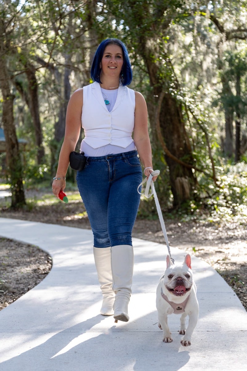 Cindi Quick smiling while walking Remi outdoors